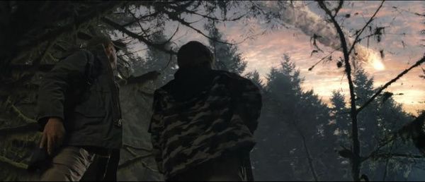 A hunter and his son watch a fireball streak across a sunset sky.