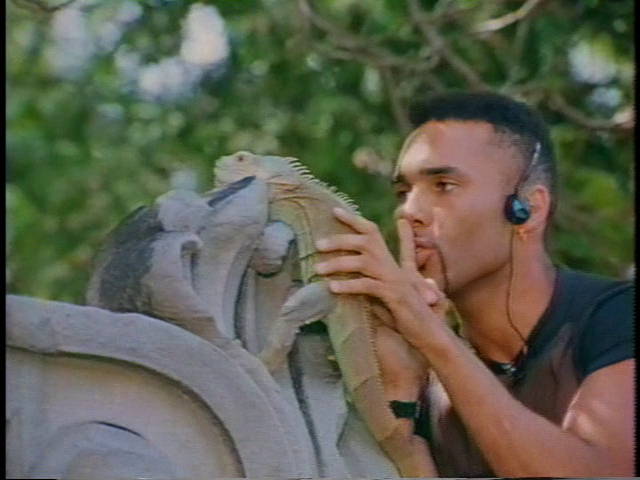 Alexander shushes his beloved pet iguana.